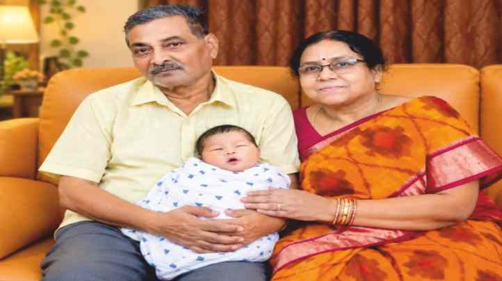 With his wife, holding a grandchild